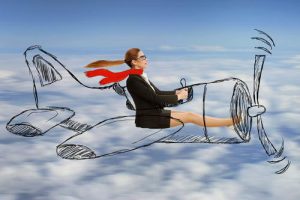 Attractive young aviator woman with scarf and glasses flying designed airplane at high altitude. Freedom travel speed expedition trip aviation transportation concept