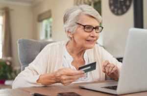 depositphotos_211967234-stock-photo-happy-senior-woman-making-online_i