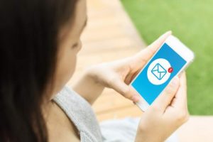 Asian young woman hand holding mobile phone with email message icon on screen
