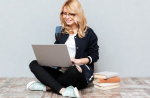 cheerful-young-woman-student-using-laptop-computer_i