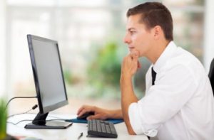 1-depositphotos_32445771-stock-photo-young-businessman-looking-at-computer_i