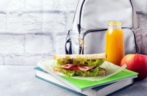 snack-school-with-sandwich-fresh-apple-orange-juice-colorful-school-supplies-copy-space_i