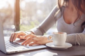 1-a-girl-is-working-at-a-laptop-in-a-cafe-on-a-sunny-day_77190-881_i